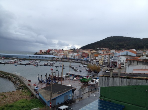 Looking at a bit of a downward angle into Finisterre (pronounced "Fisterra" here, in the Galacia dialect). The houses and boats add spots of color to the water and sky which are often varying shades of greyish blue.
