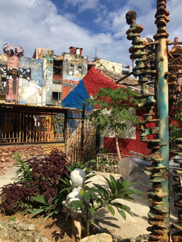  An eclectic neighborhood block full of found-items made into art; loads of color!