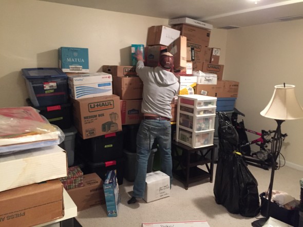 Getting some help stacking all the boxes..the wall ended up filled almost to the ceiling!