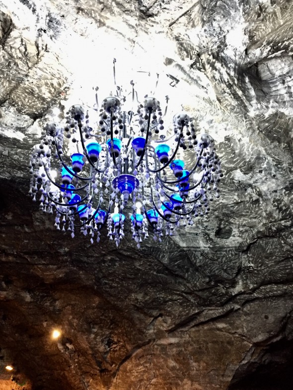 A very unique blue-glass chandelier that used to be lit with candles and now is electrified.  The effect is mysterious and beautiful.
