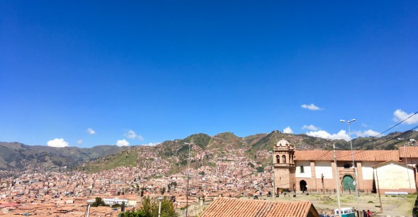 There are many tile roofs in Cusco; the architecture is Spanish colonial, lots of cobbled stone streets, and many surrounding green hills (in which you can find a plethora of Incan ruins)